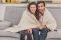 Young couple relaxing in their apartment, lying on the couch, watching a movie. Royalty Free Stock Photo