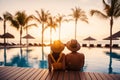 young couple relaxing in tropical resort swimming pool and enjoying the sunset. romantic summer vacation Royalty Free Stock Photo