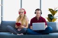 Young couple relaxing using laptop and tablet on sofa Royalty Free Stock Photo