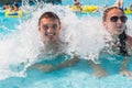 Young Couple Relaxing in Waves of Wave Pool Royalty Free Stock Photo