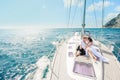 Young Couple Relaxing on a Yacht. Happy wealthy man and a woman by private boat have sea trip. Royalty Free Stock Photo
