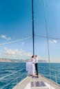 Young Couple Relaxing on a Yacht. Happy wealthy man and a woman by private boat have sea trip. Royalty Free Stock Photo