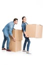 young couple relocating with carton boxes