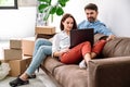 Young couple prepare to relocation and search moving service on laptop Royalty Free Stock Photo