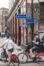 Young couple on rented Santander Cycles on a street in London