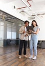 Young couple renting work space for start up business having informal meeting in open plan office Royalty Free Stock Photo