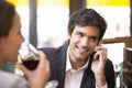 Young couple in restaurant breakfasted, man is on the phone