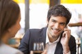 Young couple in restaurant breakfasted, man is on the phone