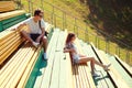 Young couple resting on a bench, youth, teenagers, fashion concept Royalty Free Stock Photo