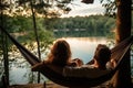 Young couple resting in hammock on the lake shore at sunset, person view couple resting at camping woman laying in hammock with