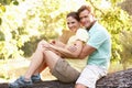 Young Couple Resting On Tree In Park Royalty Free Stock Photo