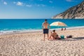 A young couple rests on the Myrtos beach, Kefalonia island, Greece during summer sea vacation. Royalty Free Stock Photo