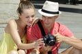 Young couple reviewing photographs on camera display Royalty Free Stock Photo