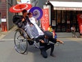 Young couple in rickshaw, Tokyo, Japan