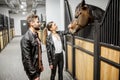 Couple with horse in the stable Royalty Free Stock Photo