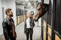 Couple with horse in the stable Royalty Free Stock Photo