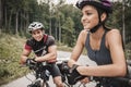 Young Couple Riding on Bicycles at Forest Road. Royalty Free Stock Photo
