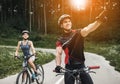 Young Couple Riding on Bicycles at Forest Road. Royalty Free Stock Photo