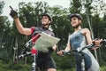 Young Couple Riding on Bicycles at Forest Road. Royalty Free Stock Photo