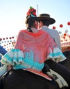 Young couple riding at horse in the Seville Fair, feast in Spain Royalty Free Stock Photo