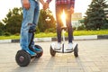 A young couple riding hoverboard - electrical scooter, personal Royalty Free Stock Photo