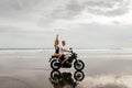 Young couple riding motorcycle on the beach