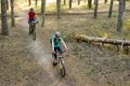 Young Couple Riding the Mountain Bikes in the Pine Forest. Adventure and Family Travel Concept. Royalty Free Stock Photo