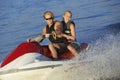 Young Couple Riding PWC On Lake Royalty Free Stock Photo