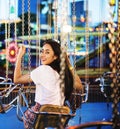 Young couple riding the swings at an amusement park