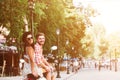 Young couple riding a vintage scooter in the street Royalty Free Stock Photo