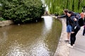 Young couple by the river Windrush - Bourton on the Water