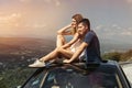 Young couple on road trip travel by car together and enjoy the nature view from the top Royalty Free Stock Photo