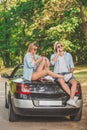 Young couple on road trip using smartphones. Modern lifestyle concept. Royalty Free Stock Photo