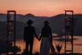 Young couple on a romantic date near the lake and mountains during sunset in a bohemian style Royalty Free Stock Photo