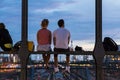 Young couple on romantic date on urban railway bridge, Munich, Germany.