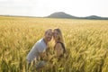 Young couple in a romantic place. Couple in love outdoors in a wheat field embracing Royalty Free Stock Photo