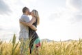 Young couple in a romantic place. Couple in love outdoors in a wheat field embracing Royalty Free Stock Photo