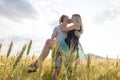 Young couple in a romantic place. Couple in love outdoors in a wheat field embracing Royalty Free Stock Photo