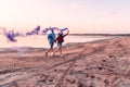 Young couple running with hand flare or fusee Royalty Free Stock Photo