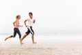 Young Couple Running Along Winter Beach Royalty Free Stock Photo