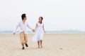 Young Couple Running Along Winter Beach Royalty Free Stock Photo