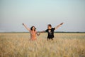 Young couple running in a field