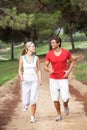 Young couple running in park Royalty Free Stock Photo