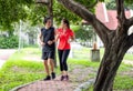 A young couple running in the park, Sport and love are combined in this concept, with a sporty man and woman working out together Royalty Free Stock Photo