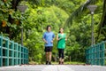 A young couple running in the park, Sport and love are combined in this concept, with a sporty man and woman working out together Royalty Free Stock Photo
