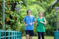 A young couple running in the park, Sport and love are combined in this concept, with a sporty man and woman working out together Royalty Free Stock Photo