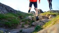 Young Couple Running on the Rocky Trail in Mountains in the Morning. Active Lifestyle Concept