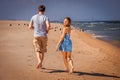 Young couple of man and woman runing on beach Royalty Free Stock Photo