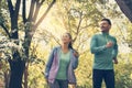 Young couple running together in park. Young people exercising. Royalty Free Stock Photo