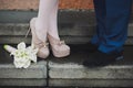 Young couple's legs. Woman and man in love. First date. Dating. Proposal. Lovers kissing. Beautiful calla lily flowers Royalty Free Stock Photo